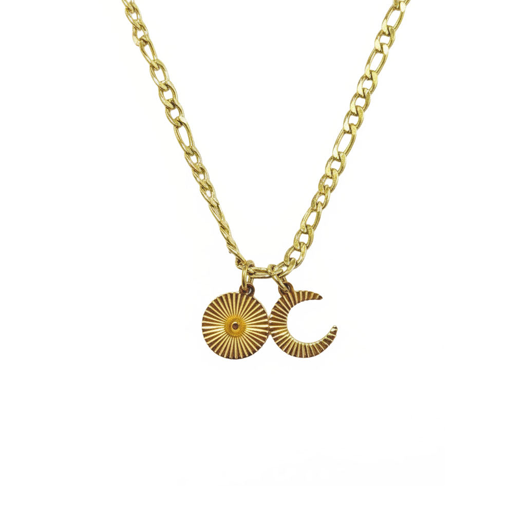 Gold necklace with sun and moon charms on a white background
