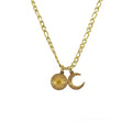 Gold necklace with sun and moon charms on a white background