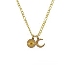 Gold necklace with sun and moon charms on a white background